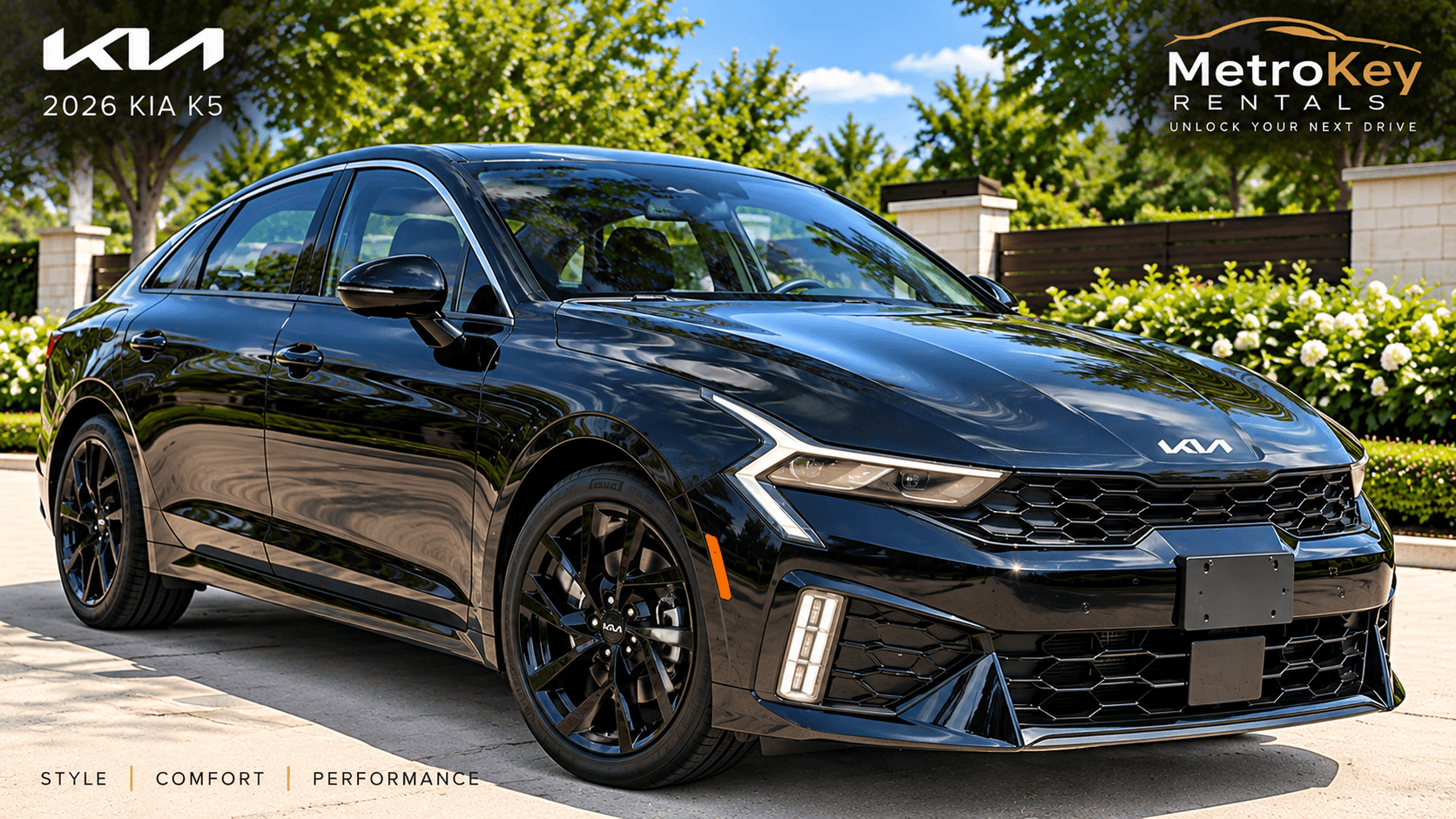 Sleek black 2026 Kia K5 sedan parked outdoors with black wheels and green trees.